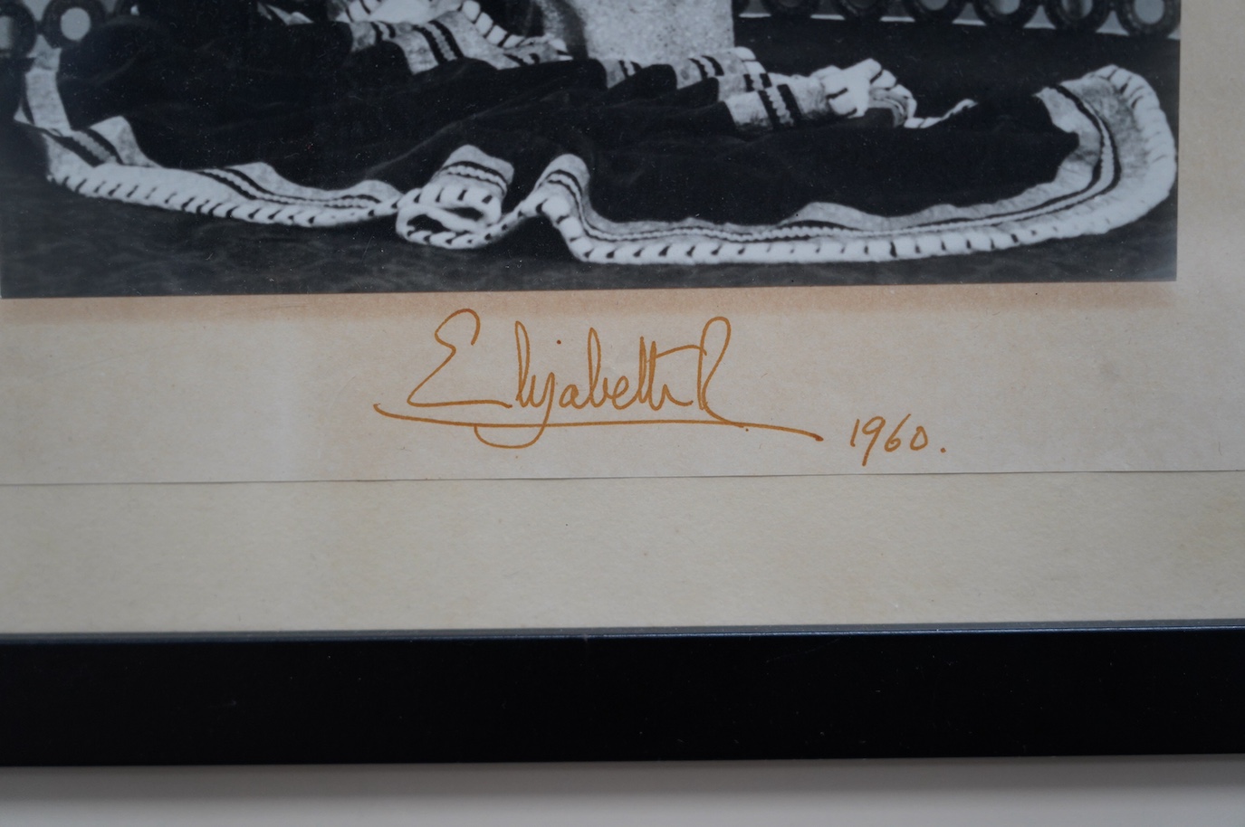 A signed photograph of Queen Elizabeth II, dated 1960 and issued for display in a British Embassy overseas, signed in the mount, 30 x 20.5cm. Condition - good